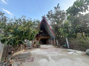 a house in the woods with a fence at Private home in Kampot