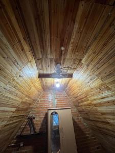 a room with a ceiling fan and a brick wall at Private home in Kampot
