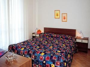リニャーノ・サッビアドーロにあるLa Torre Sabbiadoroのベッドルーム(カラフルなキルトの大型ベッド付)