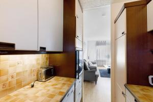 a kitchen with white cabinets and a living room at Bruchköbel auch für Monteure in Bruchköbel