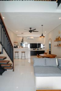 a living room with a couch and a table at Modern 1BR Loft style with pool in Pegending in Dalung