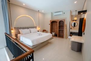 a bedroom with a large white bed and a balcony at Modern 1BR Loft style with pool in Pegending in Dalung +42 photos