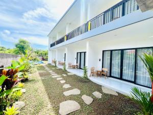 an external view of a building with a patio at Chevana House Jimbaran in Jimbaran