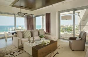a living room with a couch and a table at The Ritz-Carlton, Herzliya in Herzliya