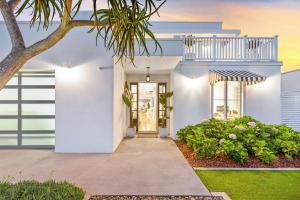 a white house with a tree and a walkway at Coastal Luxe - Hampton inspired in Kingscliff