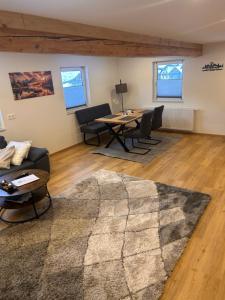a living room with a table and chairs at MyAlpenloft 1 in Deutschgriffen