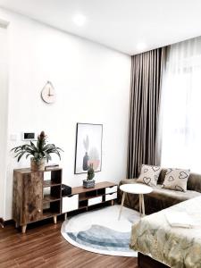 a living room with a couch and a table at Capsule Masterise Vinhomes in Gia Lâm Pho +12 photos