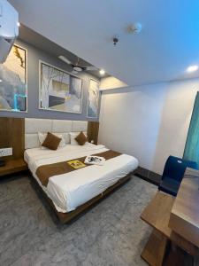 a bedroom with a large bed in a room at Hotel secure inn saroli in Surat