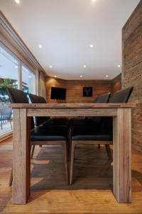 a dining room with a wooden table and chairs at Cornelia 1 Ski-In-Out Stunning Views & Sleeps 8 in Saas-Fee