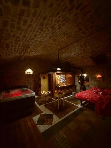 a room with a bed and a tub in a cave at Krasberry Ježev brlog in Komen +77 photos