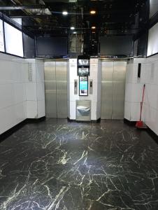 a room with a marble floor and lockers at Everest Base Cam Hostel in Hong Kong