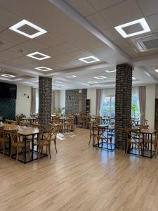 a dining room with wooden tables and chairs at Stay at Royal Kraków Golf in Ochmanów