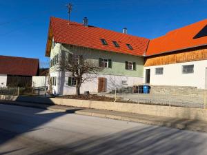 a large white building with an orange roof at Ferienhaus Winterbach - Alte Käserei in Winterbach