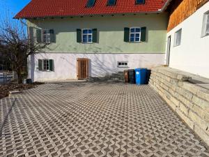 a house with a brick driveway in front of it at Ferienhaus Winterbach - Alte Käserei in Winterbach
