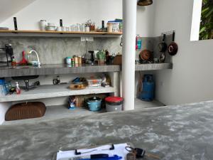 a kitchen with shelves and a sink in a room at Bamboo Garden Inn in Goiyapana +21 photos