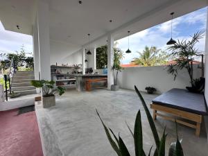 a living room with a table and potted plants at Bamboo Garden Inn in Goiyapana