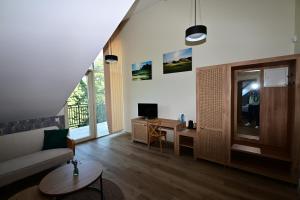 a living room with a couch and a desk at Stay at Royal Kraków Golf in Ochmanów
