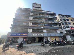 a group of motorcycles parked in front of a building at Hotel secure inn saroli in Surat