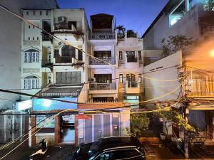 a building with a car parked in front of it at StayX Central Suites Q1 in Ho Chi Minh City