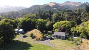 an aerial view of a house in the mountains at Okuti Country Cottage, a private and peaceful retreat in Little River