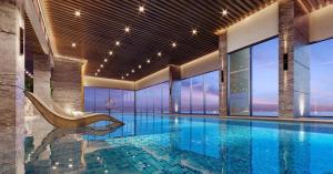 a swimming pool with a chair in a building at Capsule Masterise Vinhomes in Gia Lâm Pho