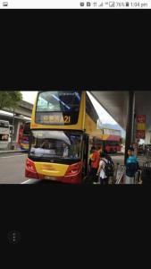 a double decker bus parked at a bus stop at Payless A2 Guest House in Hong Kong