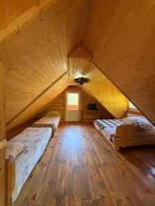 a room with two beds in a attic at Domik v gorakh in Bukovets +17 photos
