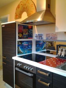 a kitchen with a stove and a sink at Les 3 Clés in Dossenheim-Kochersberg +18 photos