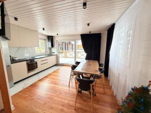 a kitchen with a table and chairs in a room at Home Hill in Kozevo