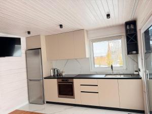 a kitchen with white cabinets and a sink and a window at Home Hill in Kozevo +17 photos