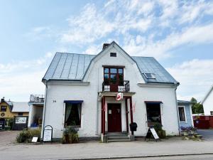 a white building with a window and a roof at Charming red cottage in Vaderstad SE10024 in Väderstad