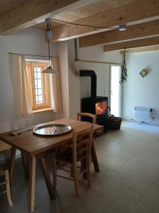 a living room with a wooden table and a fireplace at Alte Mühle Kaisersdorf in Kaisersdorf +30 photos