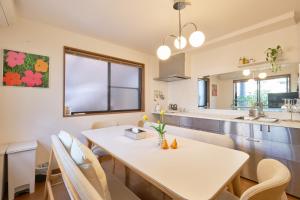 a kitchen and dining room with a white table and chairs at Yotsuya Lantern - Private 3 stories house for family in Tokyo