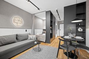 a living room with a couch and a table at City Break Śląska 8 by INA in Gdańsk