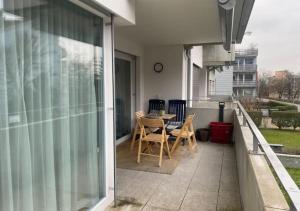 a patio with a table and chairs on a balcony at The R Apartment Adlisberg in Geroldswil