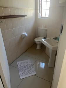 a bathroom with a toilet and a sink at Centurion Family House in Centurion +21 photos
