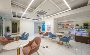 a waiting room with chairs and tables in a store at The Stay Nangman Seongseo in Daegu