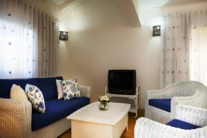 TV a/nebo společenská místnost v ubytování Condo Hotel Playa Las Ballenas