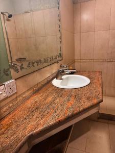a bathroom with a sink and a mirror at Reina Boutique Hotel - G9 in Islamabad +23 photos