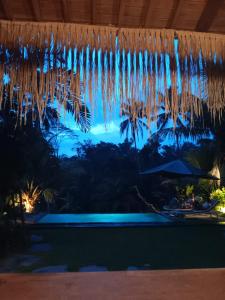 a view from the pool at night at Uma Mupu in Gianyar
