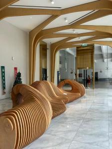 a lobby with wooden benches in a building at Spacious 3B3R Unit in BukitJalil in Kuala Lumpur +14 photos