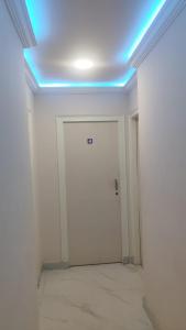 a room with a white door and a blue light at AERO View Residency in Bangalore