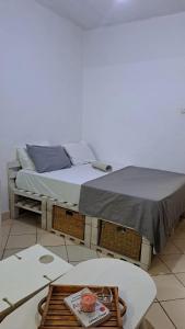 two beds in a room with a table at Kwetuh in Kwale