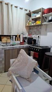 a kitchen with a sink and a stove at Kwetuh in Kwale