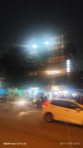 a white car driving down a city street at night at AERO View Residency in Bangalore