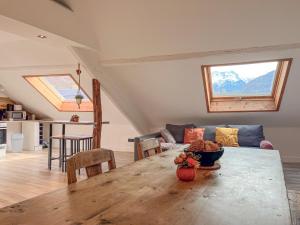 a living room with a table and a couch at Cocon sous les toits in Albertville +11 photos