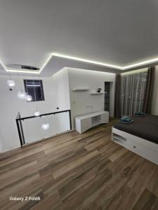 a bedroom with a bed and a wooden floor at Diljanka 4 in Pernik