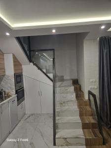 a stairway in a kitchen with a staircase in a house at Diljanka 4 in Pernik