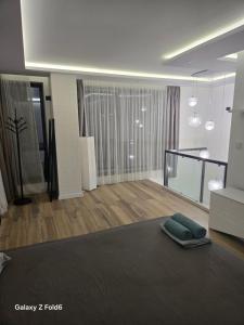 a living room with a couch and a living room with a couch at Diljanka 4 in Pernik +1 photo
