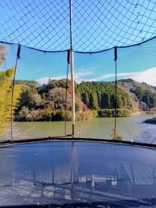 a view of a view of a lake from a window at 平沢リゾート in Ōtaki